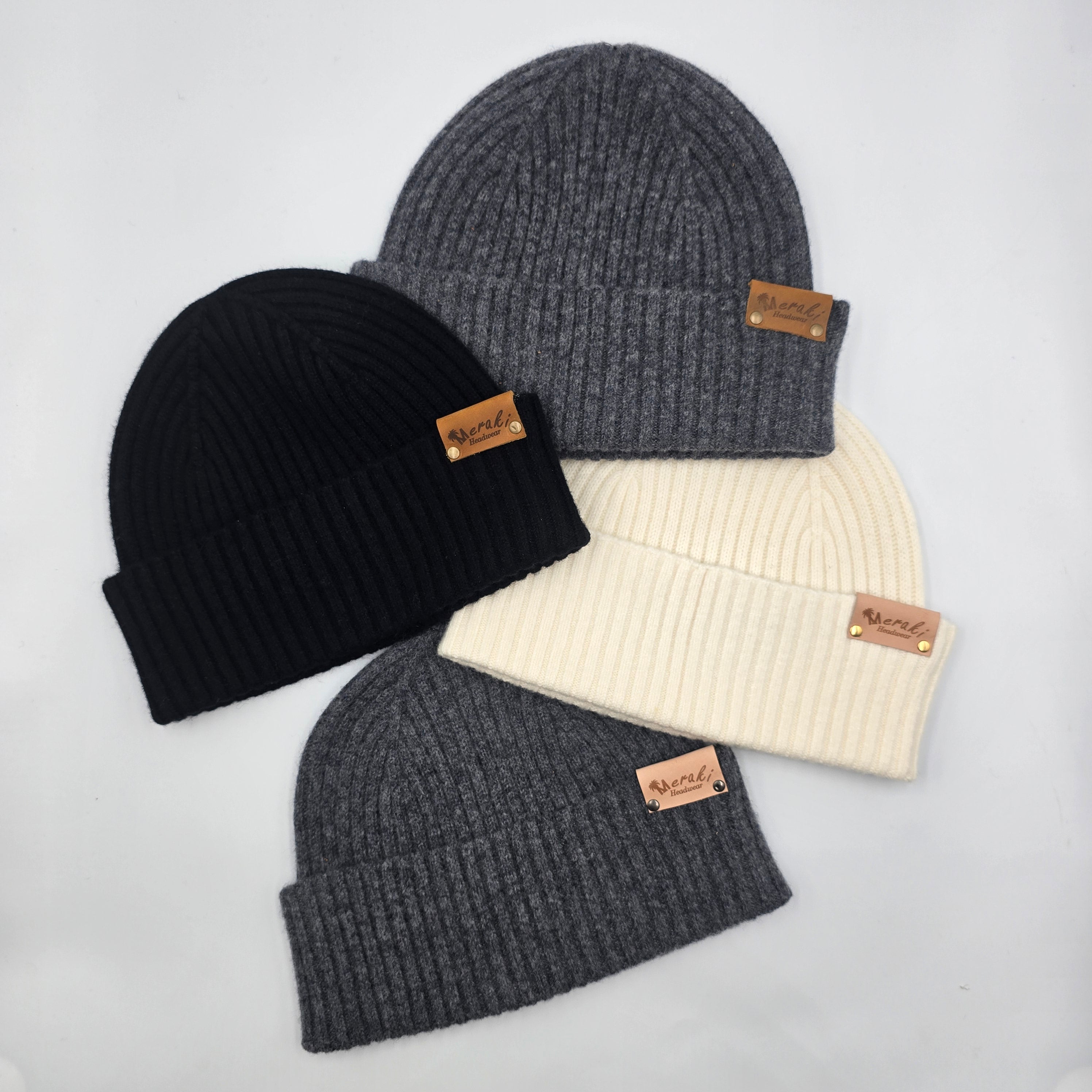 Four knit beanies in black, gray, and cream on a light gray background variant-Charcoal variant-Black variant-Cream